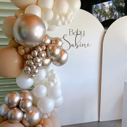 Beautiful arch with golden & white balloons baby shower setup