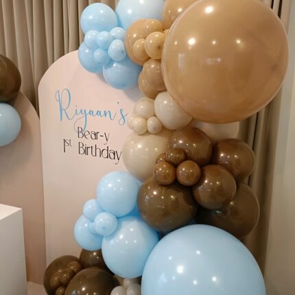 Beautiful arch with golden & white balloons baby shower setup